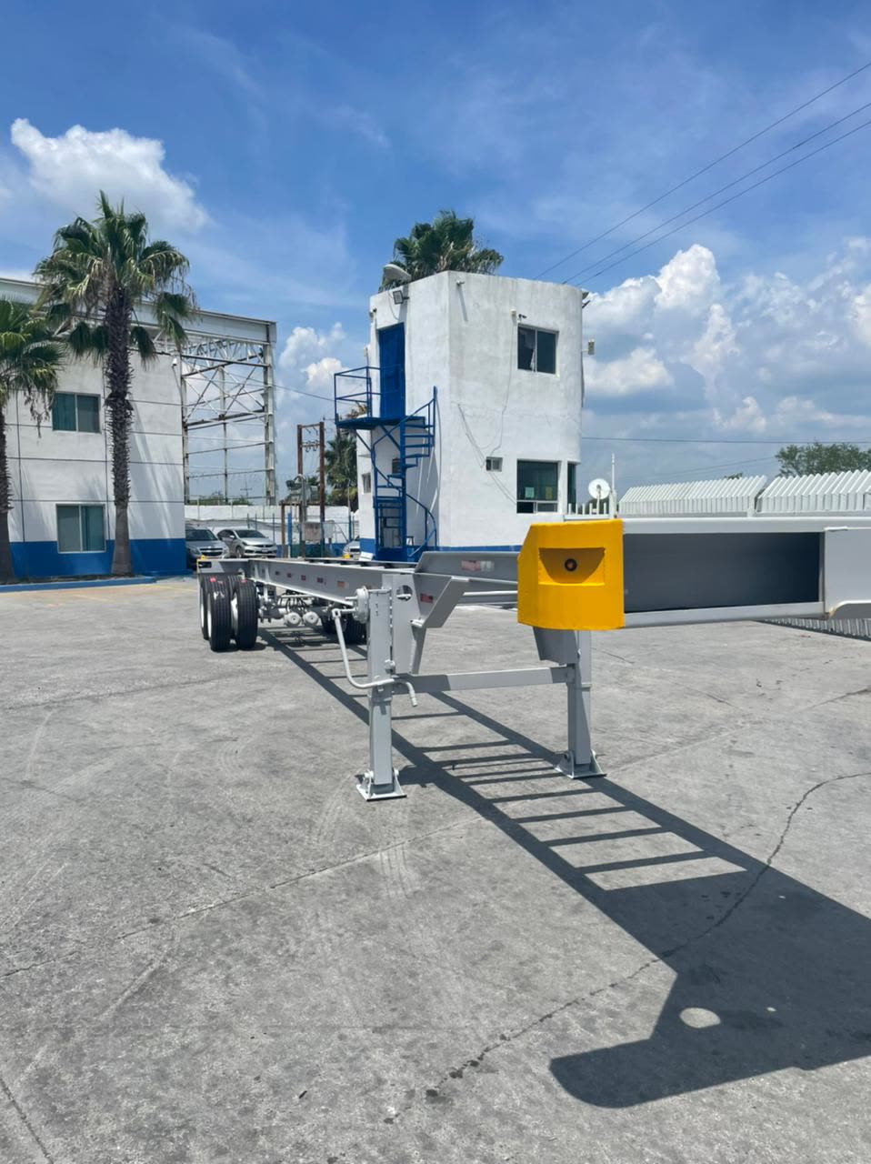 Tandem-axle container chassis parked in a yard